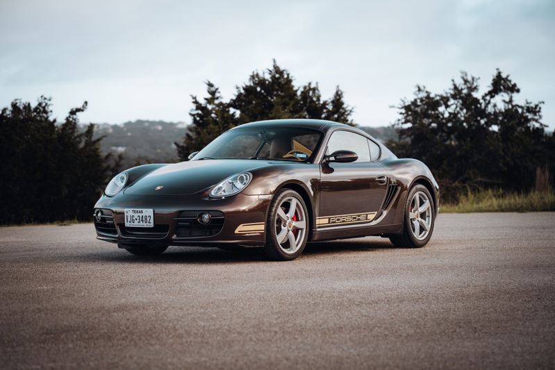Brown 2008 Porsche Cayman S with gold livery and silver rims.
