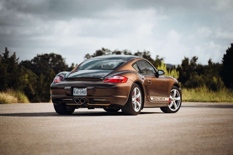 Brown 2008 Porsche Cayman S with Porsche livery and silver alloy rims.