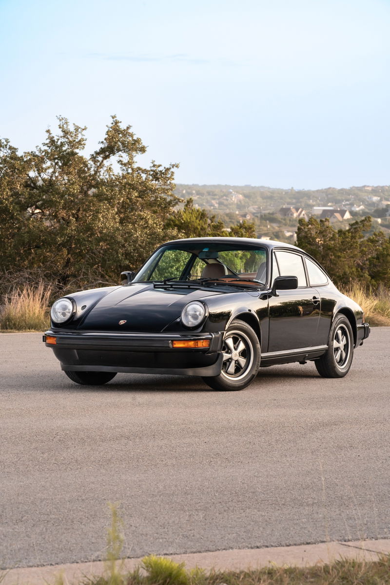 Black 1976 Porsche 911S Sportomatic coupe with Fuchs rims.