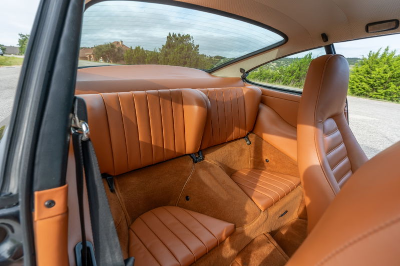 1976 Porsche 911S interior with tan leather sport seats and door trim.