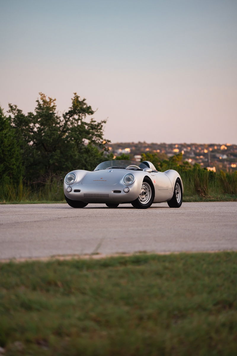 Silver Beck 550 Spyder convertible on a road, showing chrome rims and classic racing trim.
