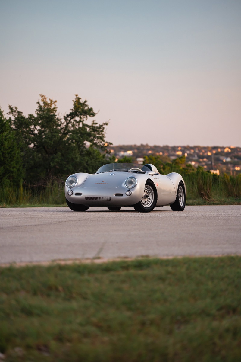 Silver Beck 550 Spyder convertible on a road, showing chrome rims and classic racing trim.