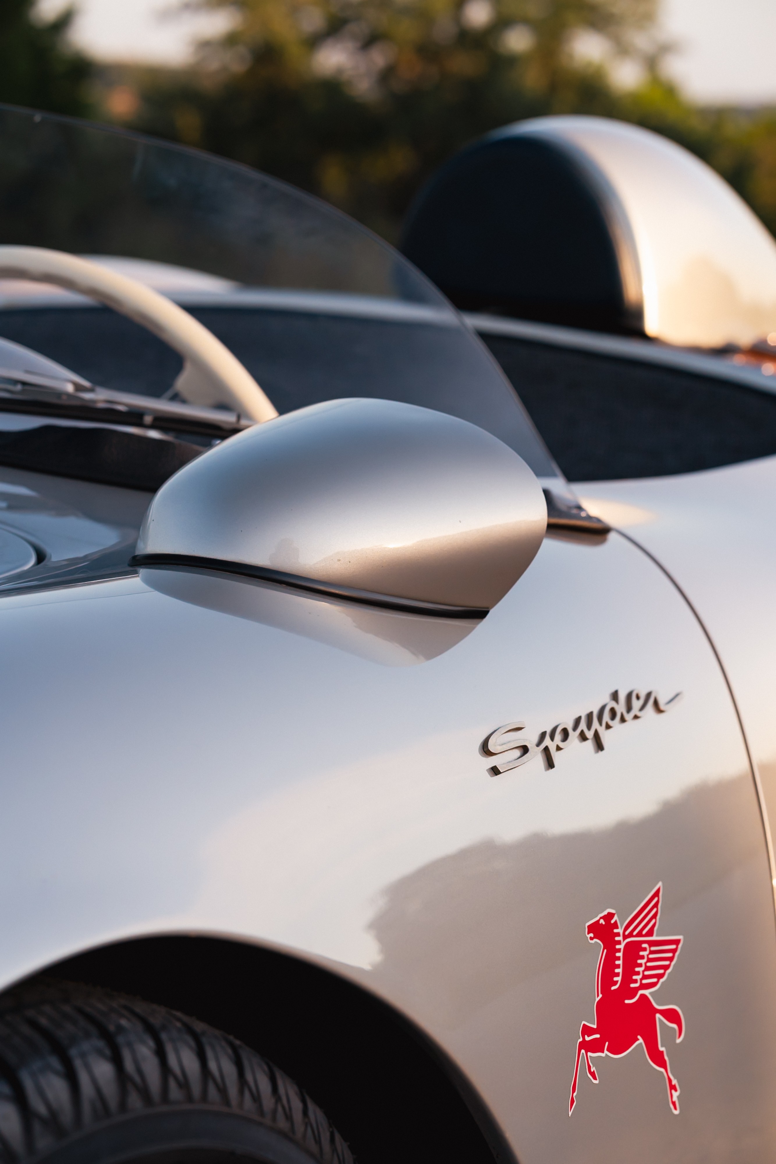 Silver Beck 550 Spyder with black trim, red Pegasus emblem, and wire wheels.