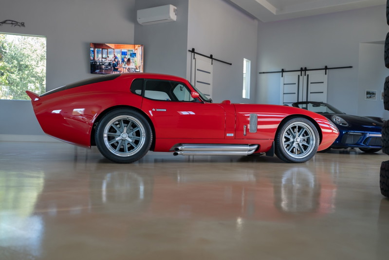Red 1965 Superformance Shelby Daytona CSX with chrome-finished multi-spoke rims.
