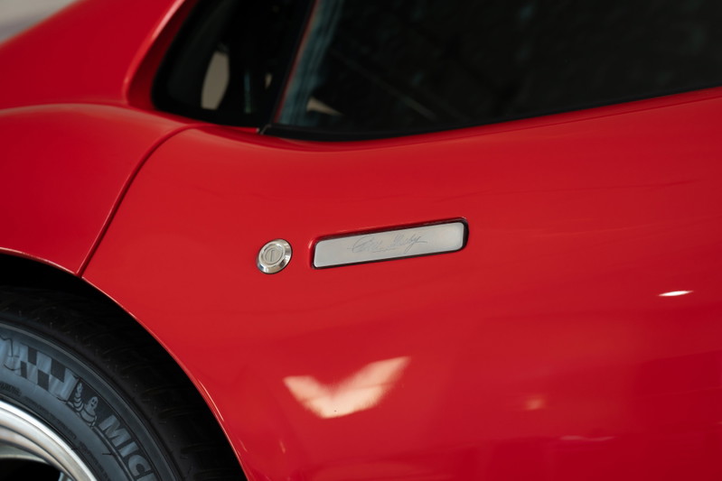 Red 1965 Superformance Shelby Daytona CSX with chrome trim and fuel filler.