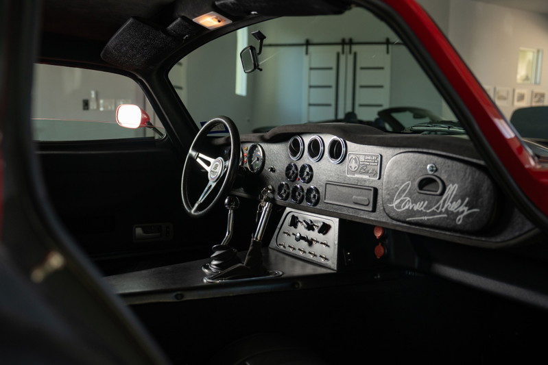 1965 Superformance Shelby Daytona CSX in Monza Red. Interior features vintage steering wheel & Shelby signature.