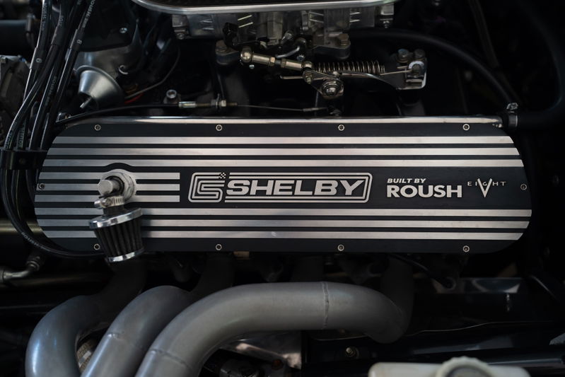Close-up of a '65 Superformance Shelby Daytona CSX engine. Features Roush branding and V8 badging.