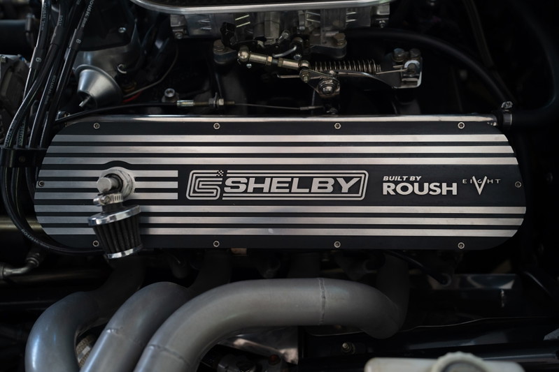 Close-up of a '65 Superformance Shelby Daytona CSX engine. Features Roush branding and V8 badging.