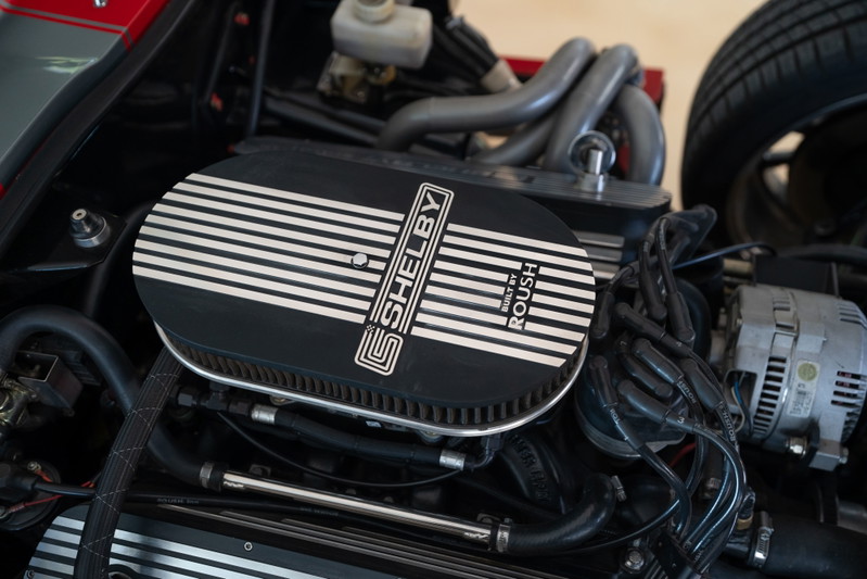 Roush-powered Shelby Daytona Cobra Coupe engine bay in Monza Red. Features a Shelby air cleaner.