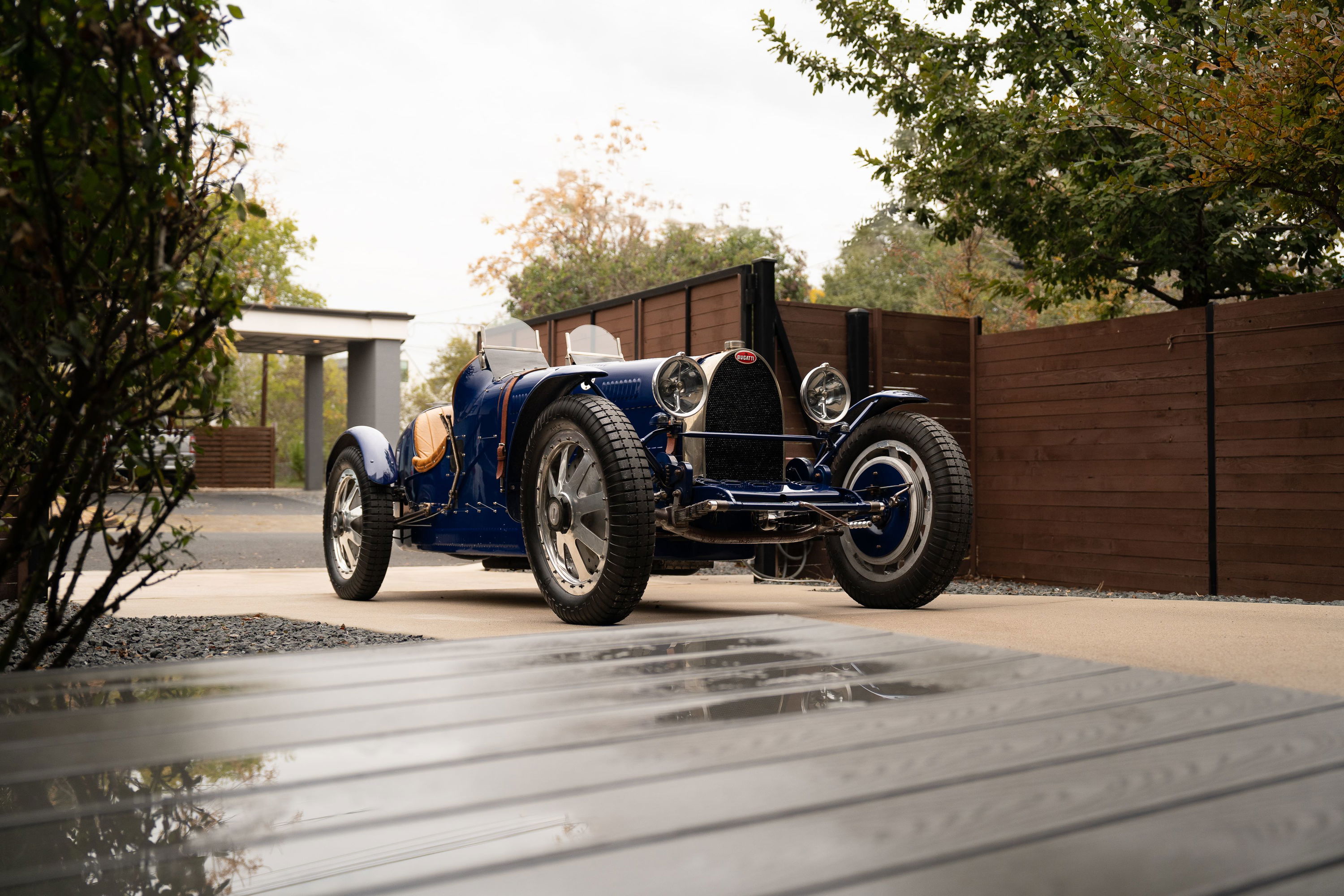 Blue 1927 Bugatti Type 35 Pur Sang roadster with silver spoke rims and tan leather seats.