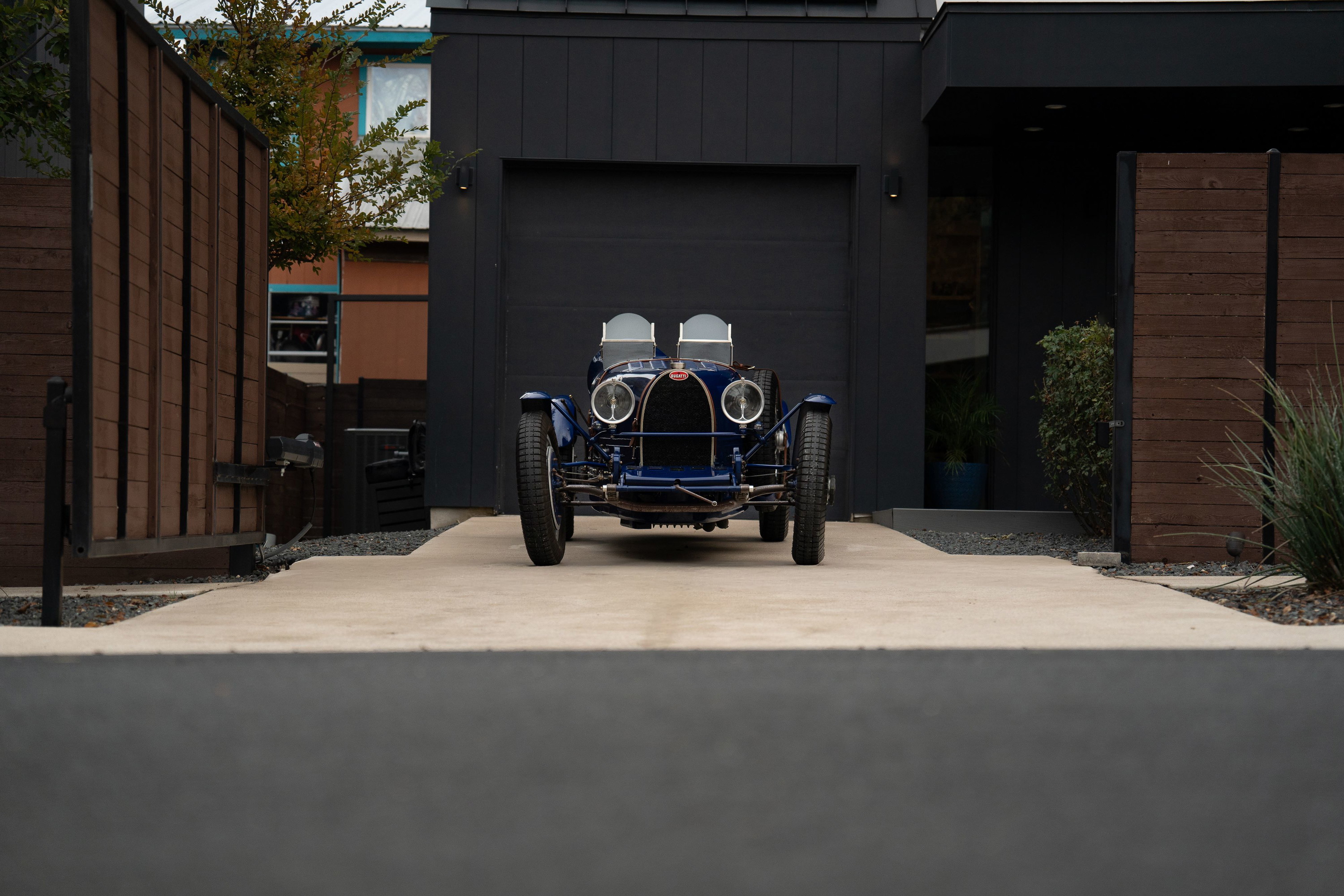 Front view of a dark blue 1927 Bugatti Type 35 Pur Sang with classic rims and chrome trim.