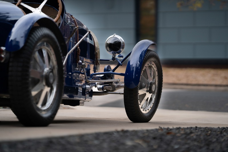Blue 1927 Pur Sang Bugatti Type 35, showing intricate chrome trim and polished rims.