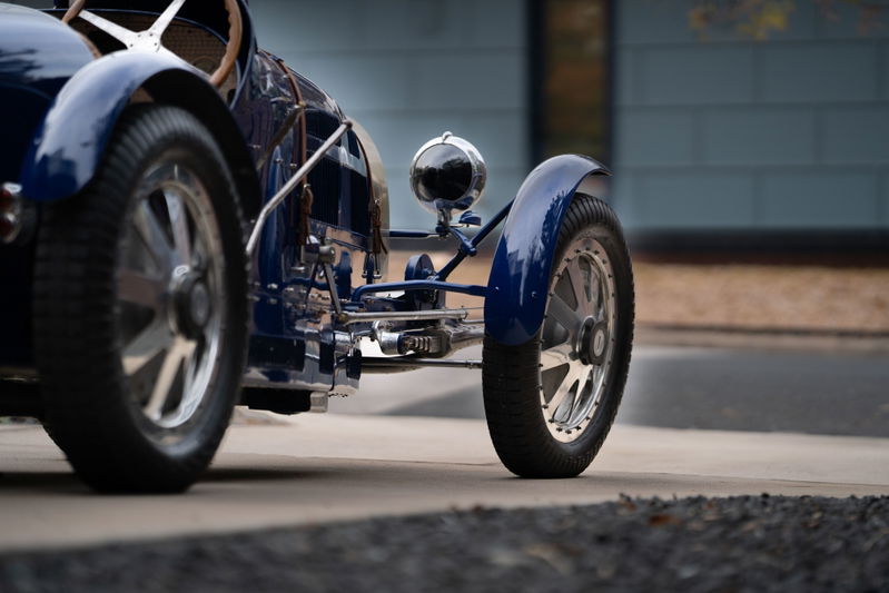 Blue 1927 Pur Sang Bugatti Type 35, showing intricate chrome trim and polished rims.