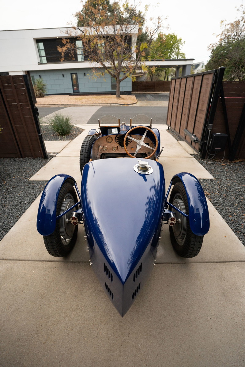 Front view of a blue 1927 Pur Sang Bugatti Type 35, showcasing its classic body and wire-spoke rims.