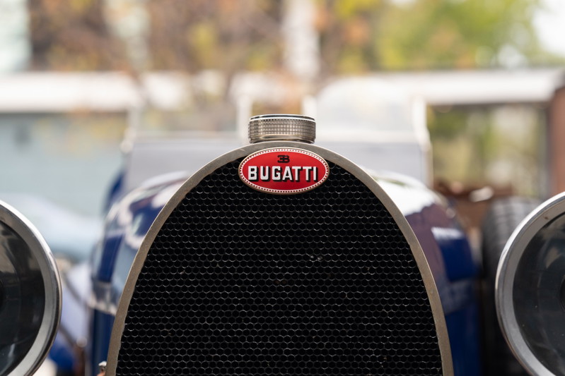 Close up of the Bugatti emblem and grille on a blue 1927 Bugatti Type 35.