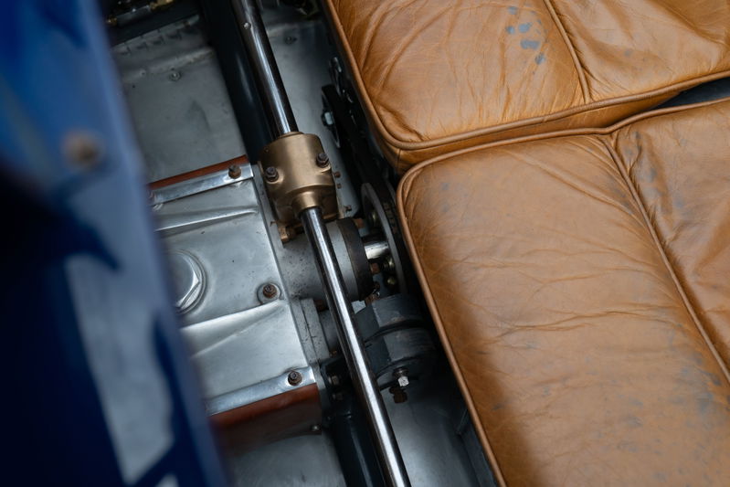 Close-up of tan leather interior and drive shaft mechanism in a blue 1927 Bugatti Type 35 Pur Sang.