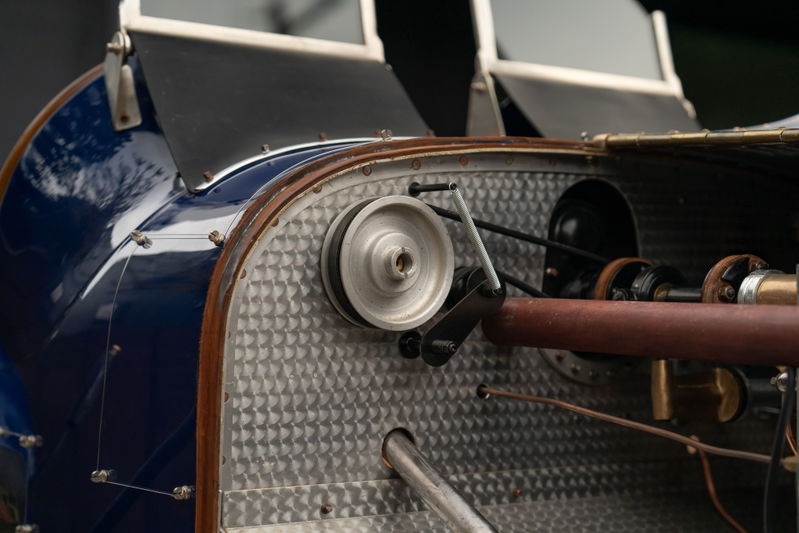 Close-up of a vintage blue 1927 Bugatti Type 35 engine bay with a pulley system.