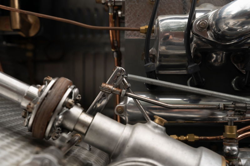 Close-up of the intricate drivetrain of a vintage blue 1927 Bugatti Type 35.