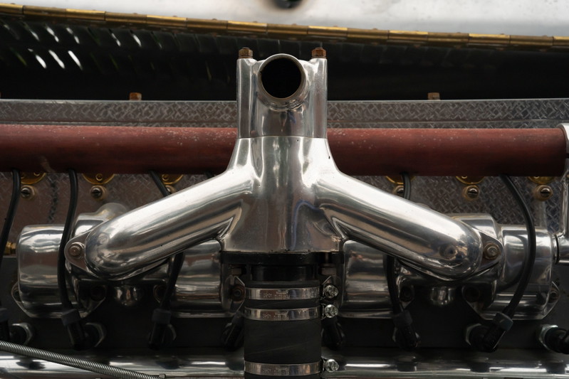 Close-up of a polished aluminum intake manifold on a 1927 Bugatti Type 35 engine.
