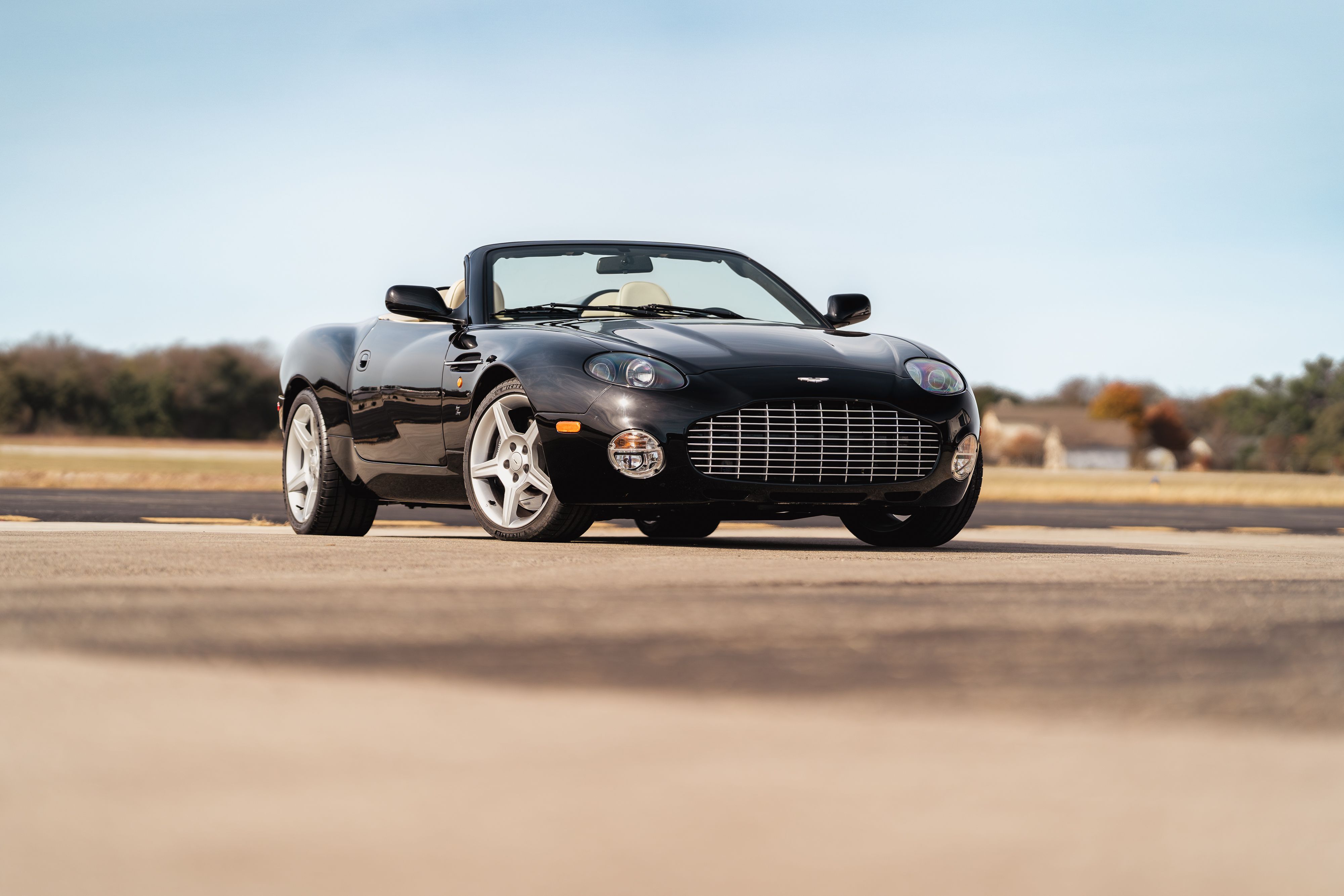 Black 2003 Aston Martin DB AR1 Zagato convertible with tan interior, on silver multi-spoke rims.