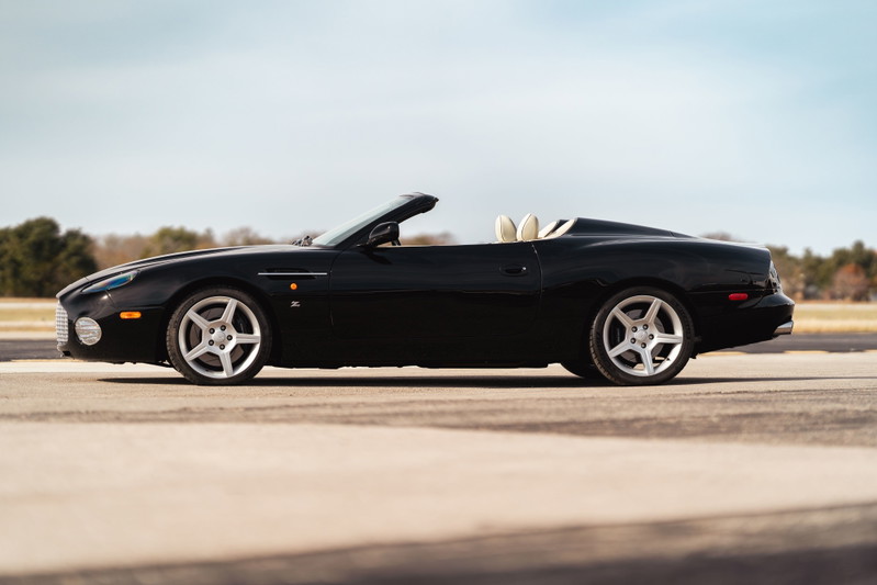 Black 2003 Aston Martin DB AR1 Zagato convertible, showing its five-spoke rims and cream interior.