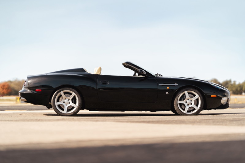 Black 2003 Aston Martin DB AR1 Zagato convertible. Features polished five-spoke alloy rims and tan interior.