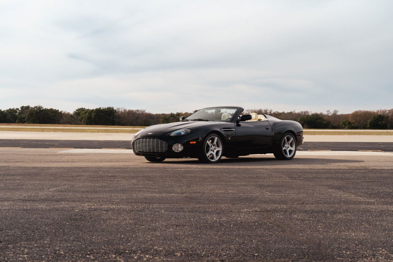 Black 2003 Aston Martin DB AR1 Zagato convertible with tan interior and silver rims.