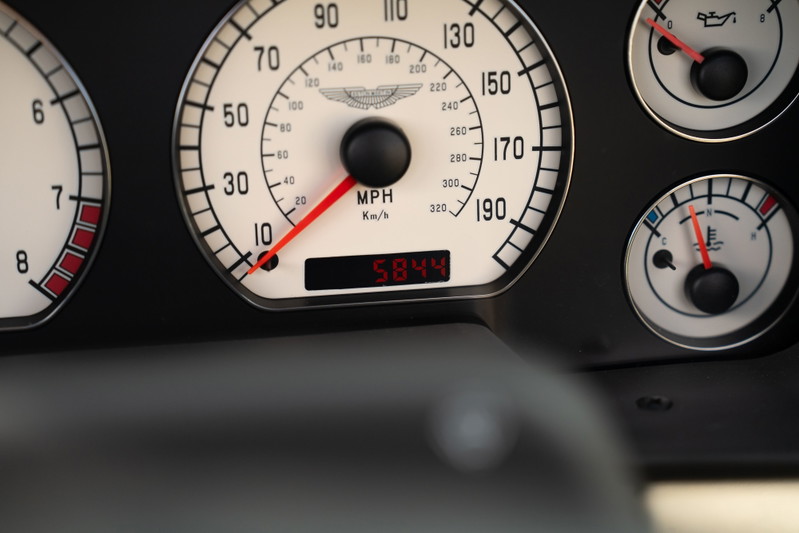 Close up of a 2003 Aston Martin DB AR1 Zagato dashboard, showing speedometer and gauges.