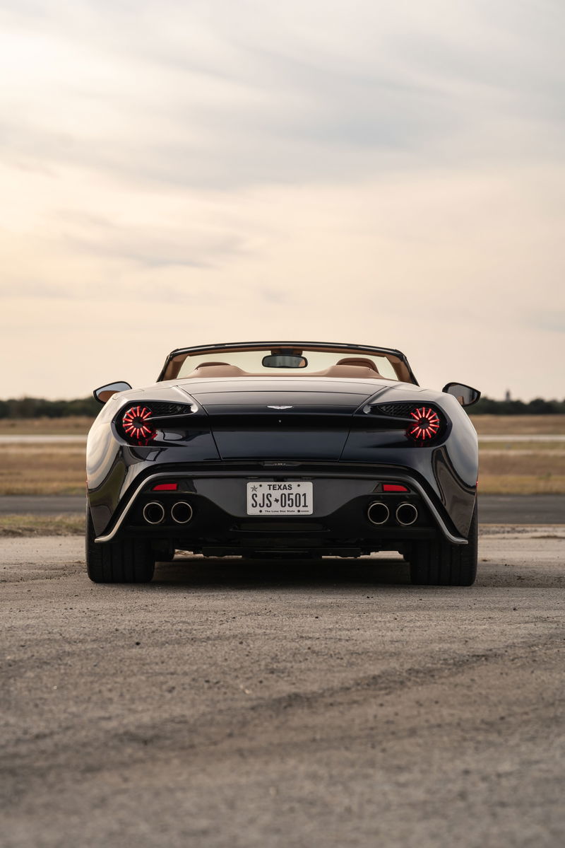 Rear view of a black 2018 Aston Martin Vanquish Zagato convertible with circular taillights.