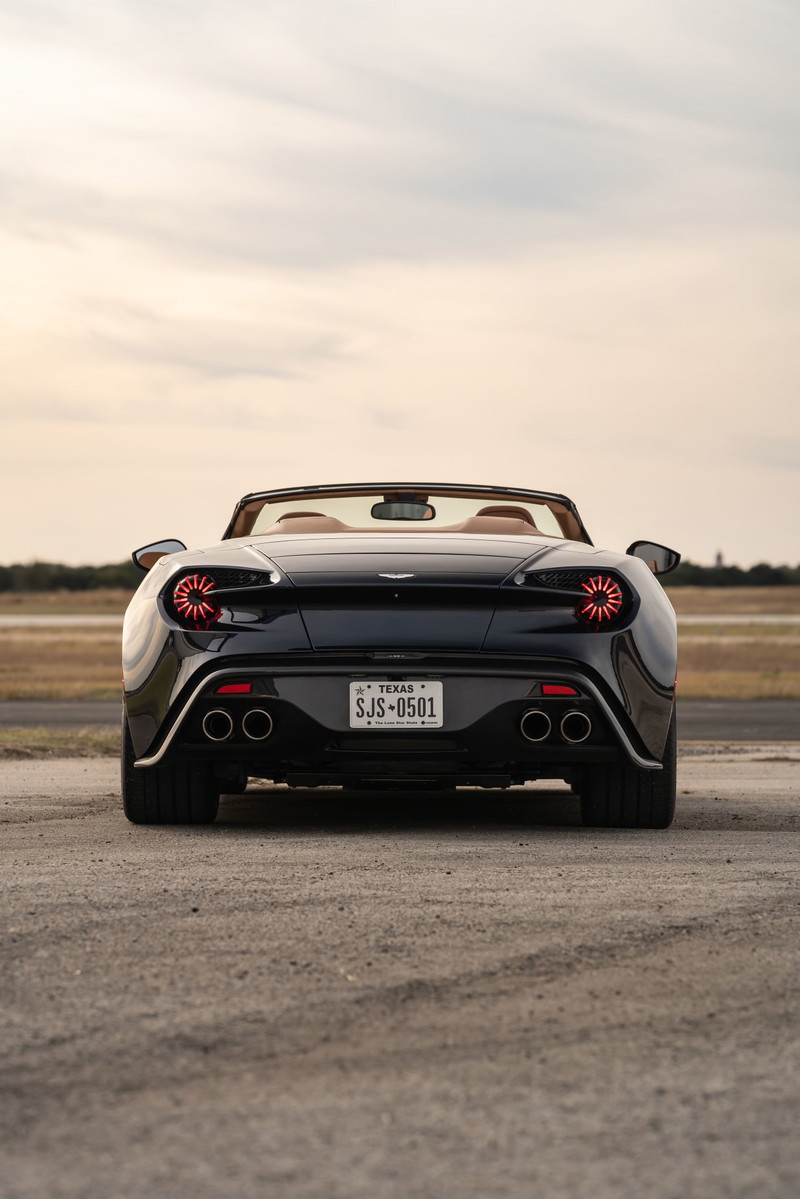Rear view of a black 2018 Aston Martin Vanquish Zagato convertible with circular taillights.