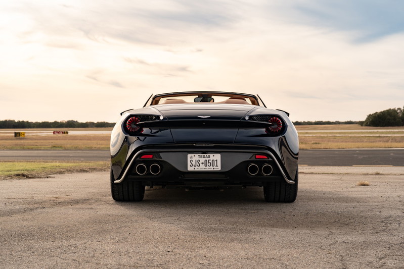 Rear view of an Orient Blue 2018 Aston Martin Vanquish Zagato with quad exhaust tips and chrome trim.
