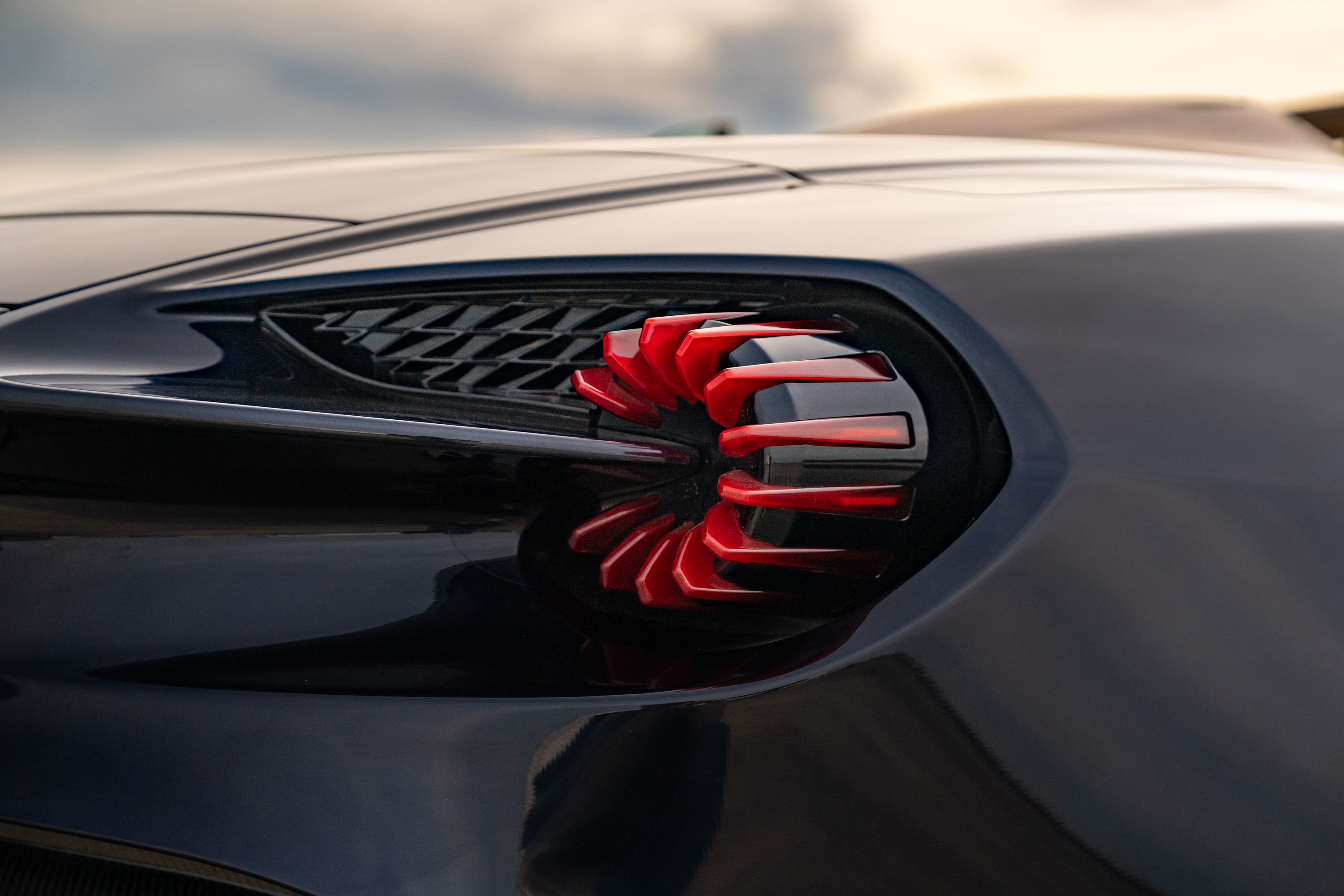 Close-up of the unique red turbine-style taillight on an Orient Blue 2018 Aston Martin Vanquish Zagato.