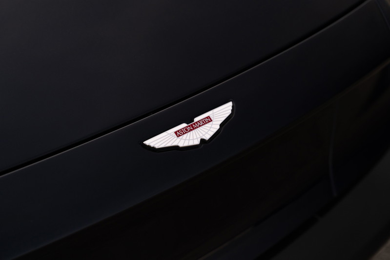 Close-up of the Aston Martin wings badge on the hood of an Orient Blue 2018 Vanquish Zagato.