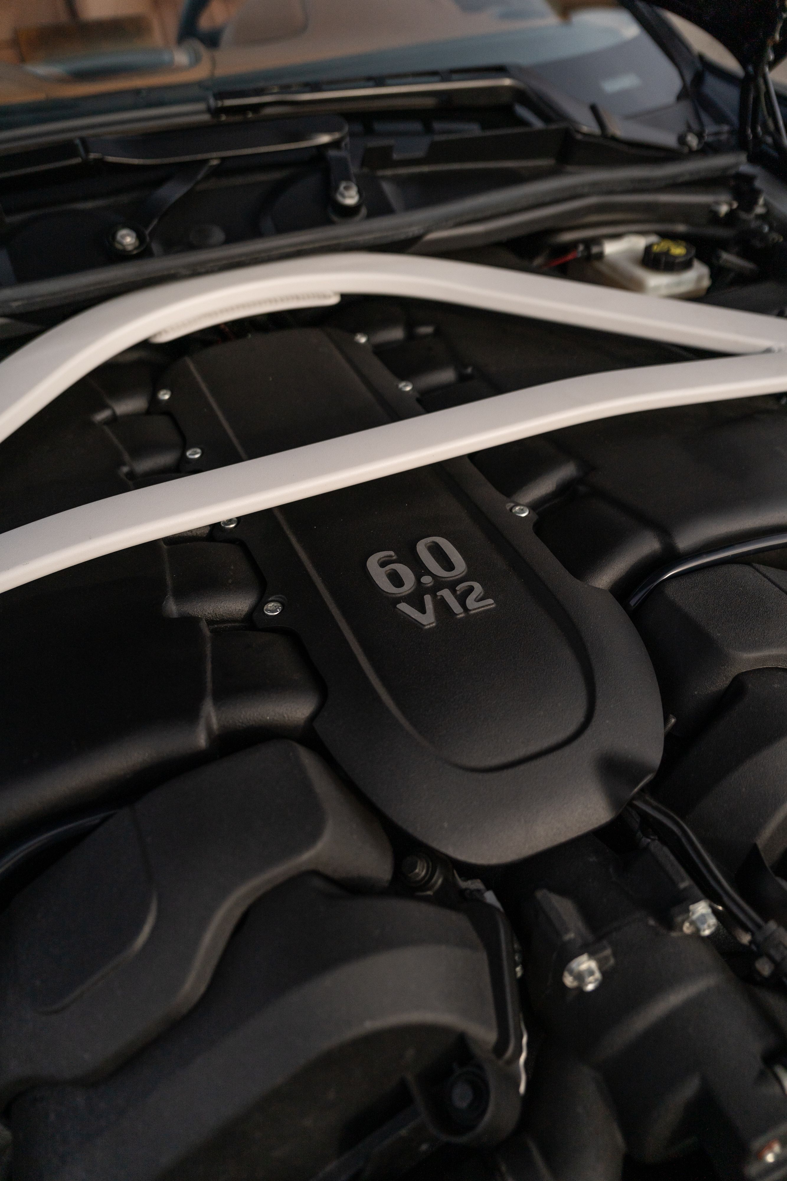 Close-up of a 2018 Aston Martin Vanquish Zagato 6.0 V12 engine with white strut brace.