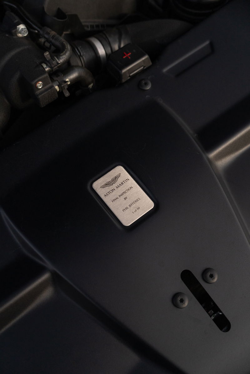 Aston Martin Vanquish Zagato engine bay with inspection plaque.