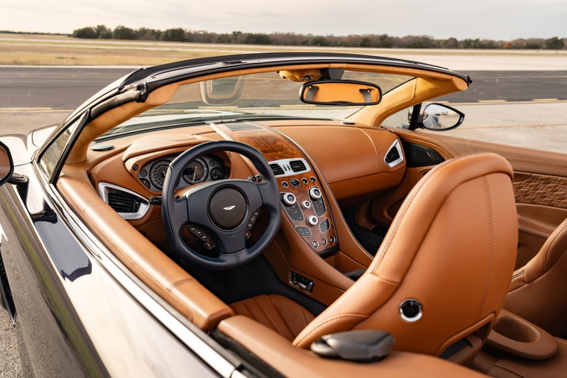 Interior view of a 2018 Aston Martin Vanquish Zagato, featuring tan leather upholstery and wood trim.