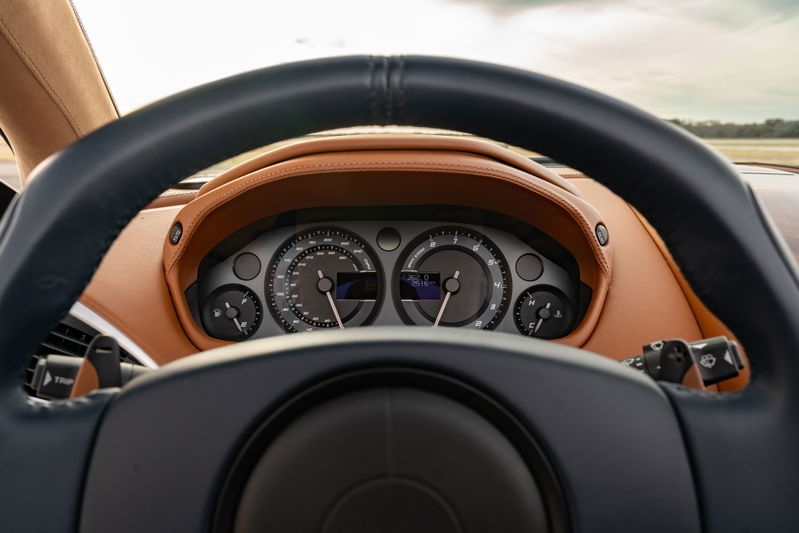 Interior view of a 2018 Aston Martin Vanquish Zagato with tan leather trim and a black steering wheel.