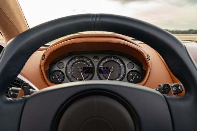Interior view of a 2018 Aston Martin Vanquish Zagato with tan leather trim and a black steering wheel.