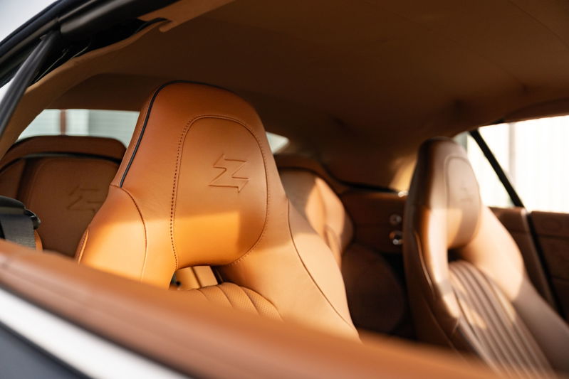 Interior of an Aston Martin Vanquish Zagato in tan leather with embossed 'Z' logo on headrests.