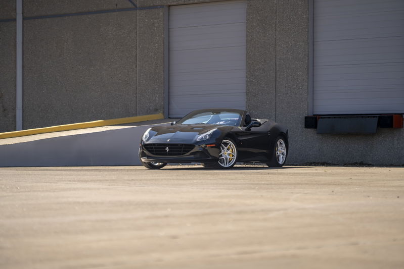Black 2016 Ferrari California T convertible with silver rims.