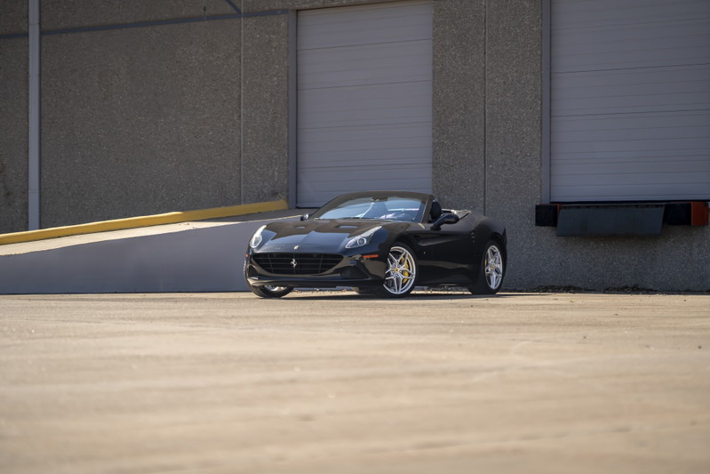 Black 2016 Ferrari California T convertible with silver rims.