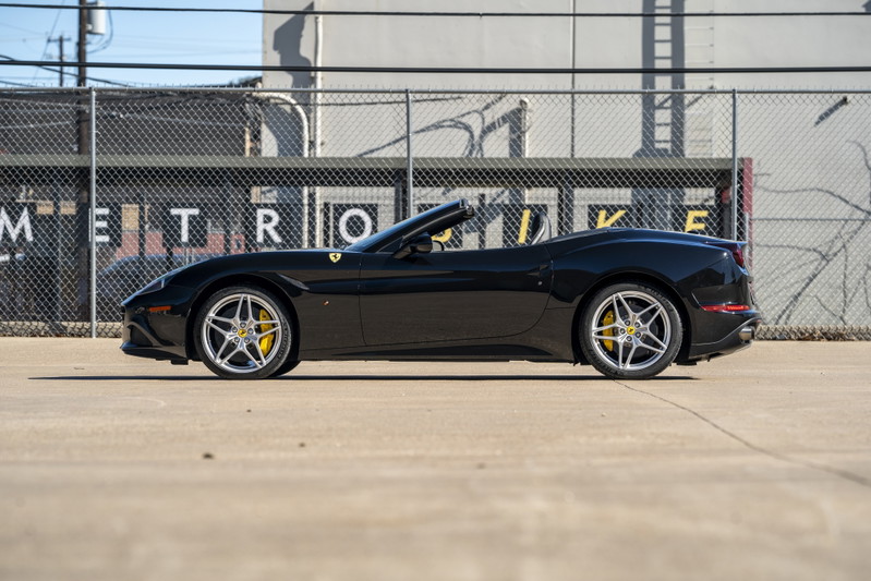Black 2016 Ferrari California T with silver rims and yellow brake calipers.