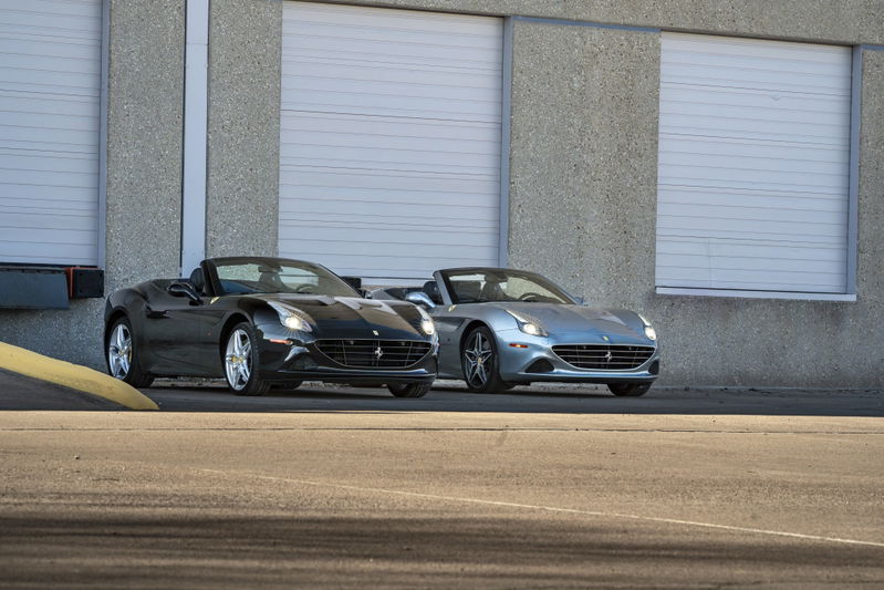 Silver 2016 Ferrari California T convertible with five-spoke rims in front of a light blue convertible with similar rims.