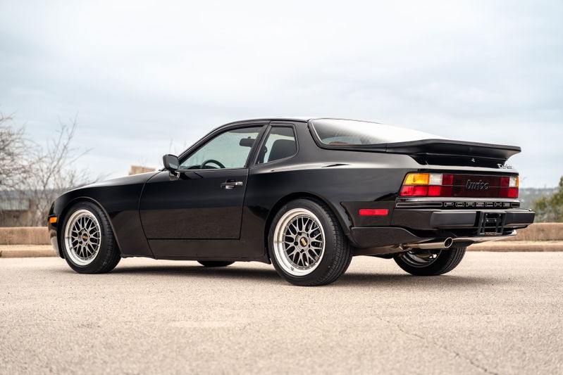Black 1986 Porsche 944 Turbo with BBS-style rims and a rear spoiler.