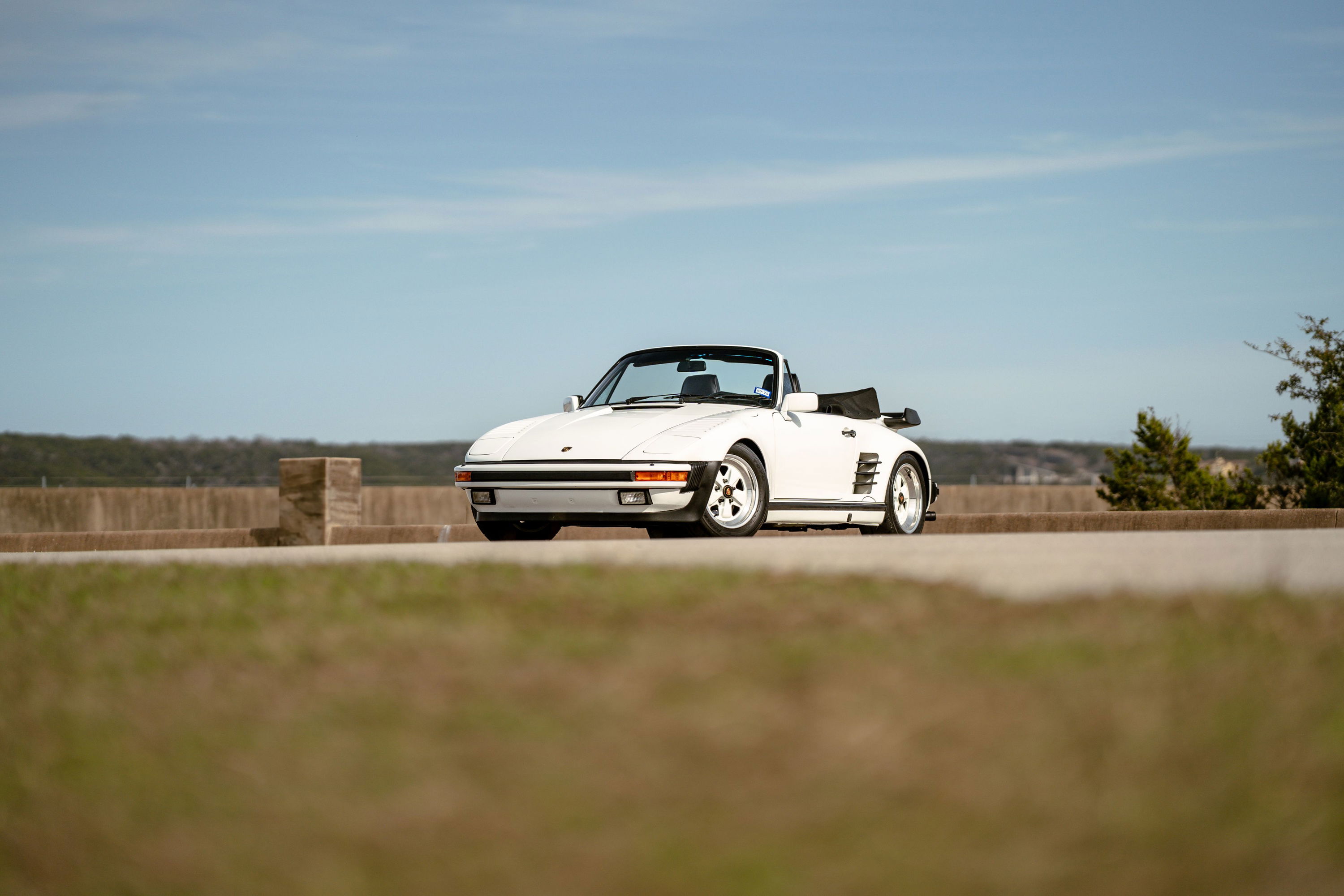 1988 Porsche 930 Turbo M505 Slantnose convertible in white, featuring black trim and iconic phone-dial rims.