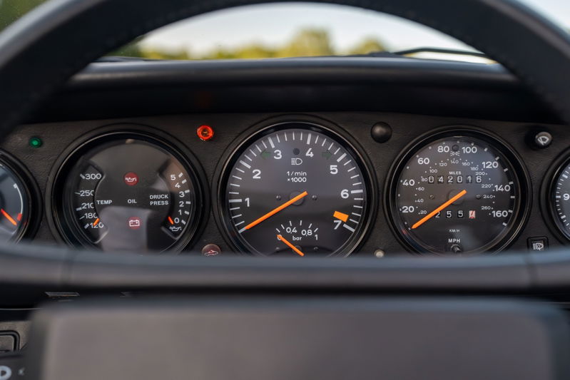 1988 Porsche 930 Turbo Slantnose dashboard with tachometer, speedometer, oil temp, and oil pressure gauges.