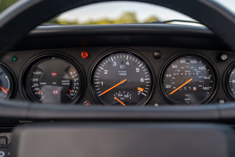 1988 Porsche 930 Turbo Slantnose dashboard with tachometer, speedometer, oil temp, and oil pressure gauges.