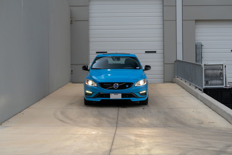 Front view of a Rebel Blue 2015 Volvo V60 Polestar on a concrete ramp.
