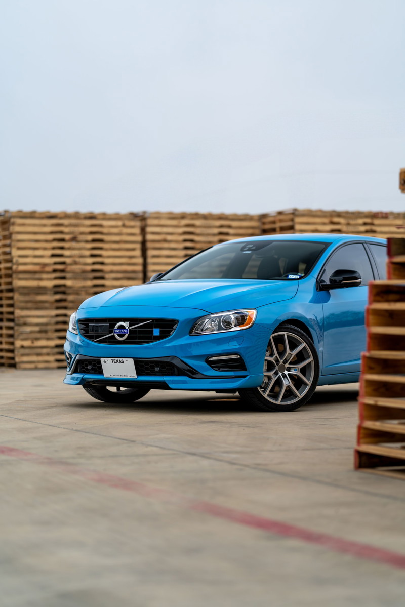 Rebel blue 2015 Volvo V60 Polestar with silver multi-spoke rims and black trim.