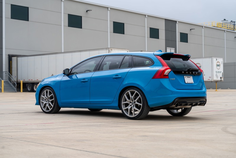 Rebel Blue 2015 Volvo V60 Polestar wagon with multi-spoke silver rims and sport trim.